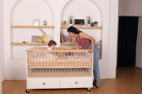Elegant Light Crib with 2 Drawers and Folding Sides